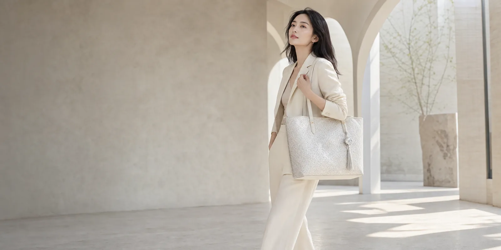 Woman carrying a white Zhuang brocade tote